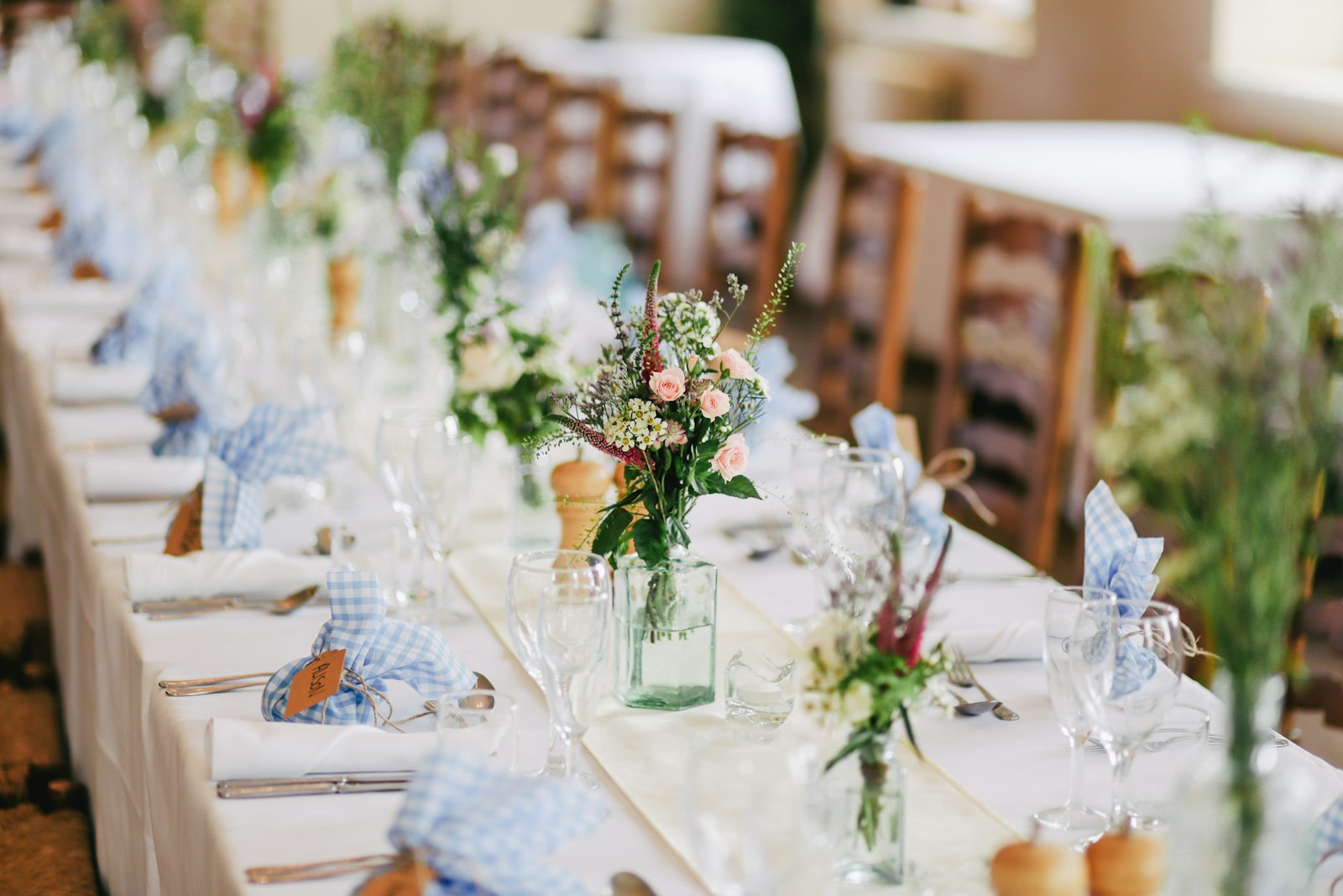 A long wedding table set with loose garden florals